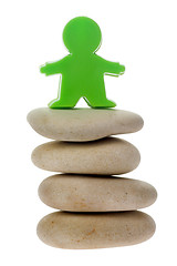 Image showing Green figurine on a stack of pebbles