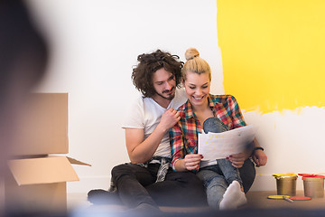 Image showing Happy young couple relaxing after painting