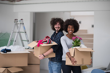 Image showing multiethnic couple moving into a new home