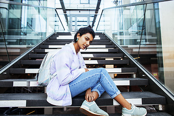 Image showing young cute indian girl at university building sitting on stairs 