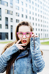 Image showing young pretty hipster girl student with coffee cup posing adorable smiling, lifestyle people concept outdoor