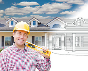 Image showing Male Contractor Wearing Hard Hat In Front of House Drawing Grada
