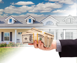 Image showing Hand Holding Stack of Money Over House Drawing Gradating Into Ph