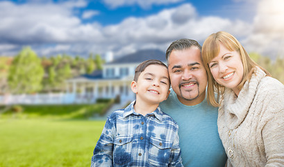 Image showing Mixed Race Family In Front Yard of Beautiful House and Property.