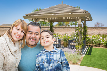 Image showing Mixed Race Family In Back Yard Near Patio Cover.