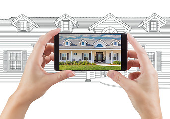 Image showing Hands Holding Smart Phone Displaying Home Photo of Drawing Behin