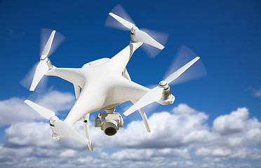 Image showing Unmanned Aircraft System (UAV) Quadcopter Drone In The Air.