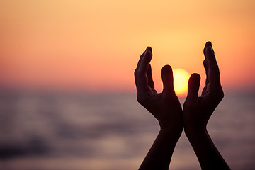 Image showing silhouette of female hands during sunset