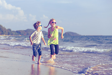 Image showing Happy children playing on the beach at the day time.