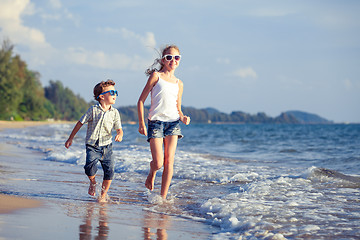 Image showing Happy children playing on the beach at the day time.