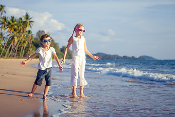 Image showing Happy children playing on the beach at the day time.