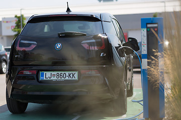 Image showing i3 BMW electric car being charged at electric car charging station.