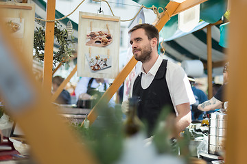 Image showing Man serving street food on international cuisine event in Ljubljana, Slovenia.