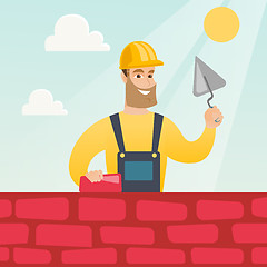 Image showing Bricklayer working with spatula and brick.