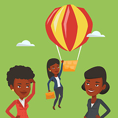 Image showing Business woman hanging on balloon.