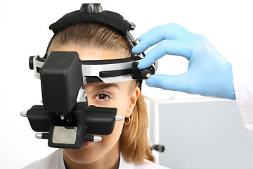 Image showing An eye exam at an ophthalmologist, ophthalmoscope