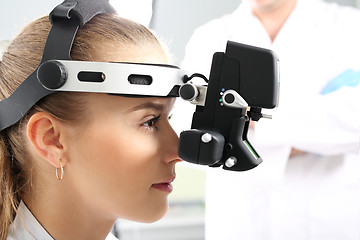 Image showing An eye exam at an ophthalmologist, ophthalmoscope