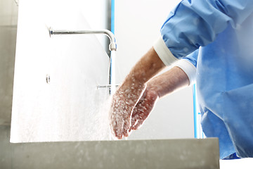 Image showing Surgical hand disinfection. The doctor washes his hands.