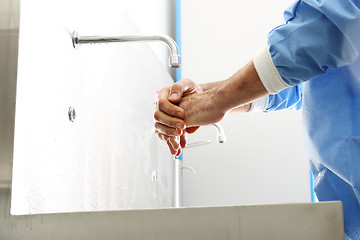 Image showing The doctor disinfects  his hands. Surgeon washing hands.