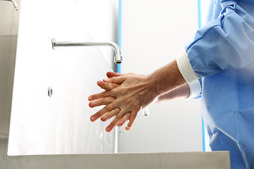 Image showing Surgical hand disinfection. The doctor washes his hands. The doctor disinfects  his hands. Surgeon washing hands.