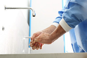 Image showing Surgical hand disinfection. The doctor washes his hands.