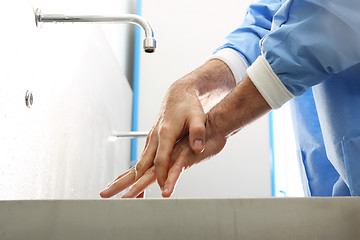 Image showing Surgical hand disinfection. The doctor washes his hands.