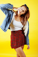 Image showing lifestyle people concept: pretty young school teenage girl having fun happy smiling on yellow background