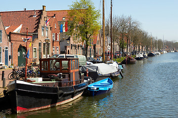 Image showing Traditional Dutch Botter Fishing Boats in the small Harbor of the Historic Fishing Village in Netherlands.