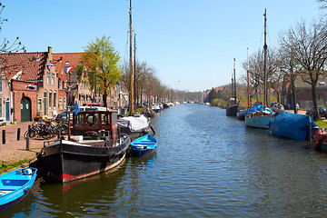 Image showing Traditional Dutch Botter Fishing Boats in the small Harbor of the Historic Fishing Village in Netherlands.