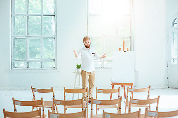 Image showing Speaker at Business Meeting in the empty conference hall.