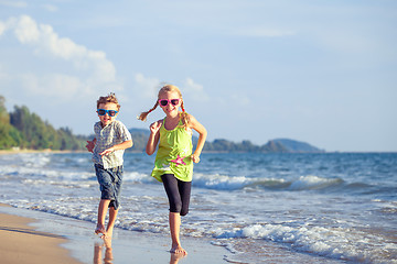 Image showing Happy children playing on the beach at the day time.