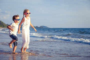 Image showing Happy children playing on the beach at the day time.