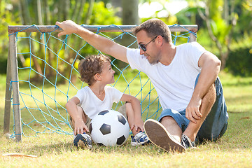 Image showing Father and son playing in the park  at the day time.