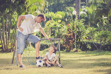 Image showing Father and son playing in the park  at the day time.