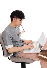 Image showing Asian man working at his laptop.