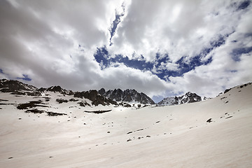 Image showing Snow mountain and cloud sky in gray spring day