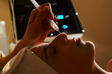 Image showing Face Beauty Treatment. Closeup Of Beautiful Woman Getting Facial Gas-liquid Oxygen Water Epidermal Peeling Using Professional Equipment At Cosmetology Center. Skin Care Concept.