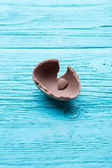 Image showing Half chocolate egg, blue table