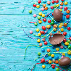 Image showing Multicolored sweets, chocolate eggs, ribbons