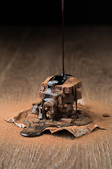 Image showing Chocolate pyramid on wooden table