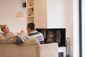 Image showing Young couple  in front of fireplace