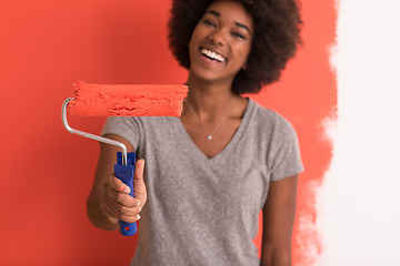 Image showing black woman painting wall