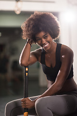 Image showing black woman after workout with hammer