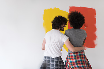 Image showing multiethnic couple painting interior wall