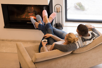 Image showing Young couple  in front of fireplace