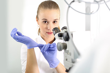 Image showing Eye clinic, ophthalmologist imposed on rubber gloves.