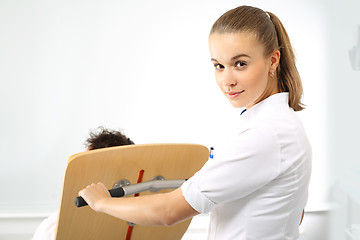 Image showing A nurse tends to a patient.