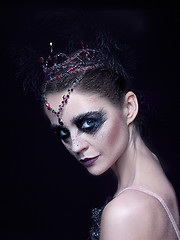 Image showing Portrait of the ballerina in the role of a black swan on black background