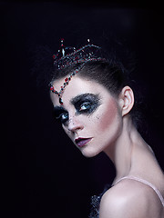 Image showing Portrait of the ballerina in the role of a black swan on black background