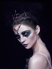 Image showing Portrait of the ballerina in the role of a black swan on black background